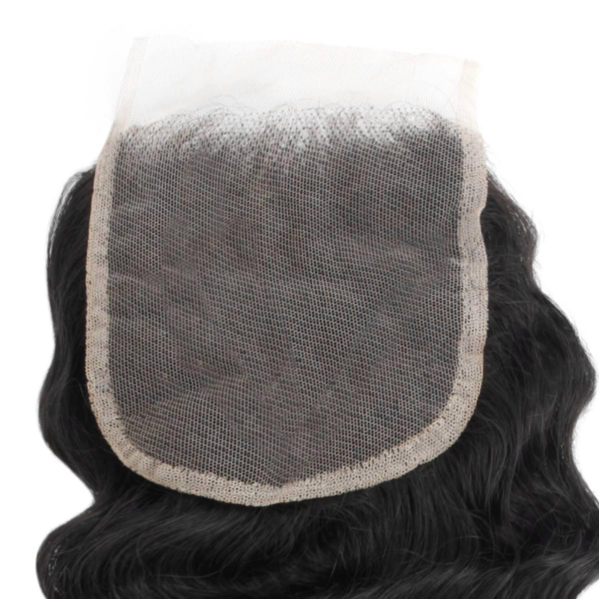 Black hairpiece with a mesh back on a white background