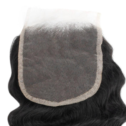 Black hairpiece with a mesh back on a white background