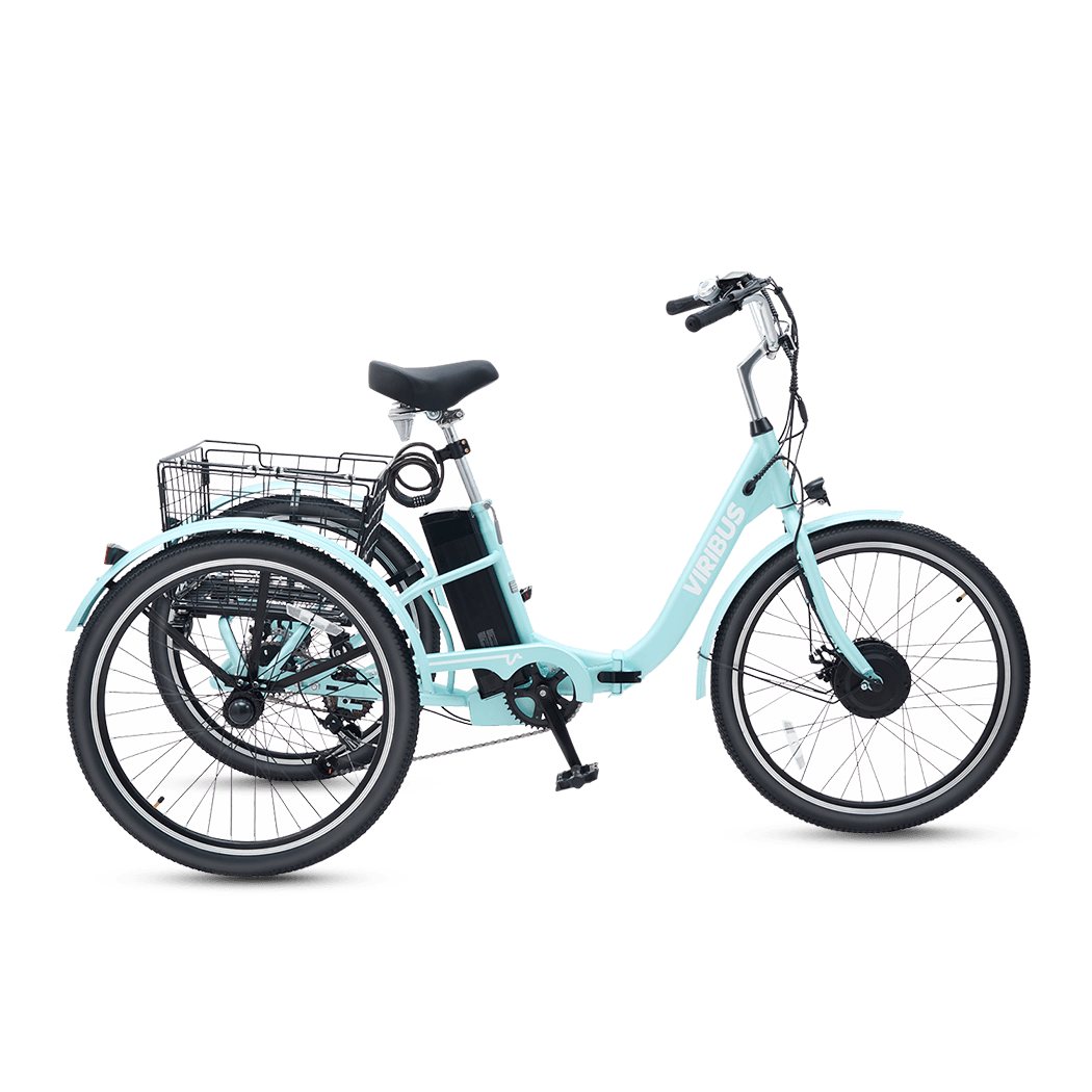 Light blue tricycle with a clear plastic container on a black background