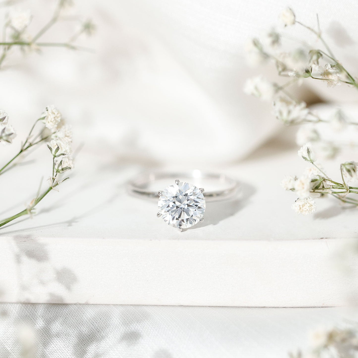 round diamond ring on floral background