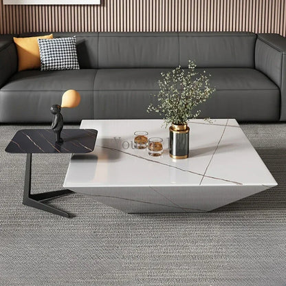Modern living room with a gray sectional sofa, marble coffee table, and decorative items.