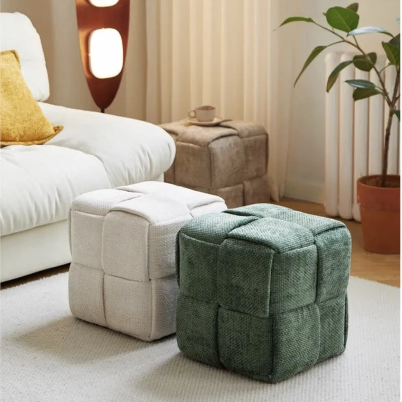 Sugar stool ottomans, one beige and one green, in a living room setting.