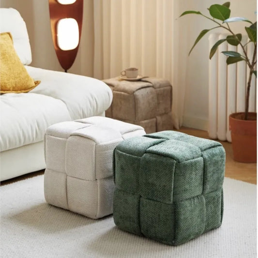 Sugar stool ottomans, one beige and one green, in a living room setting.