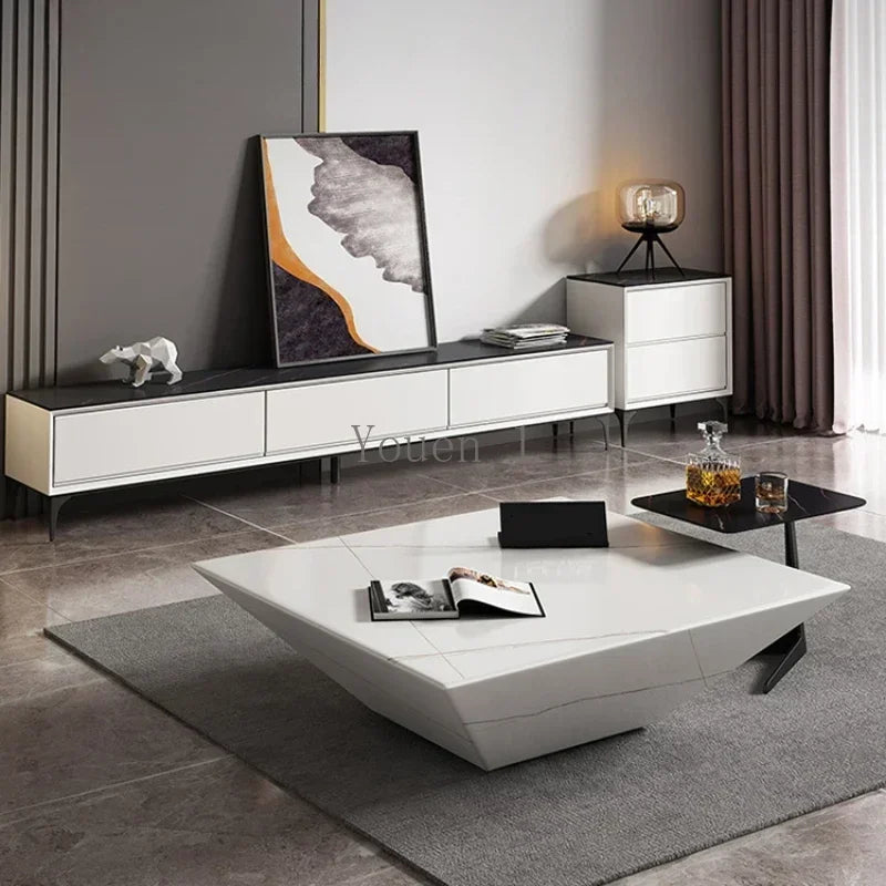 Modern living room with white furniture, including a coffee table and sideboard.