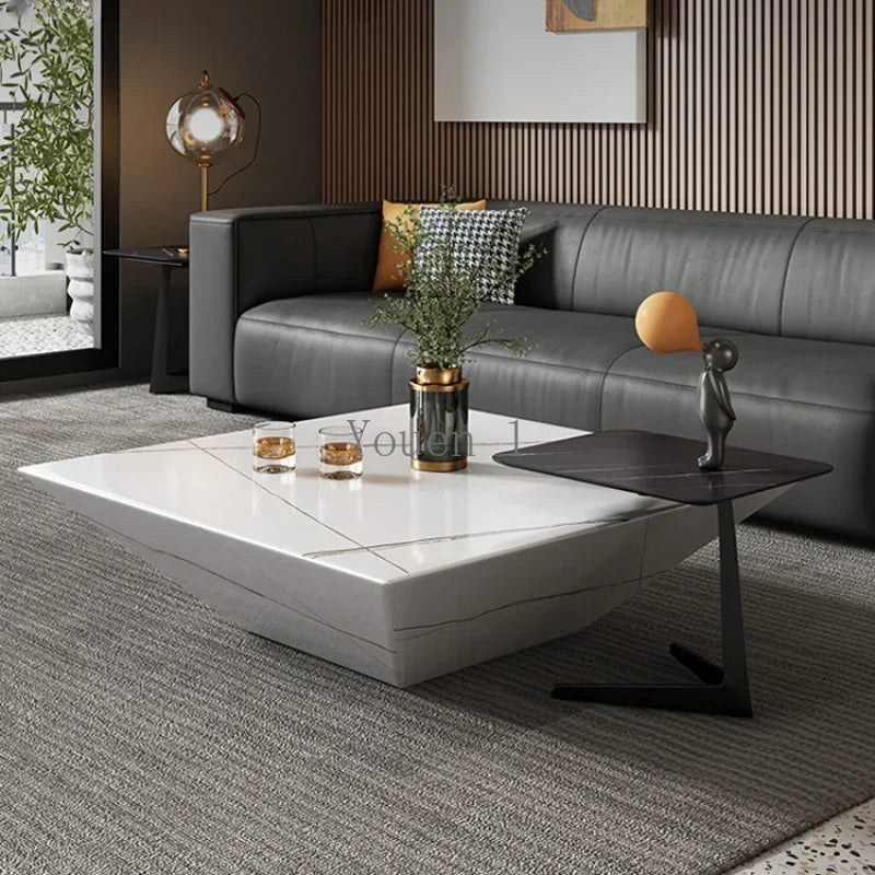 Modern living room with a gray sectional sofa and white coffee table.