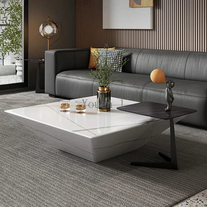 Modern living room with a gray sectional sofa and white coffee table.