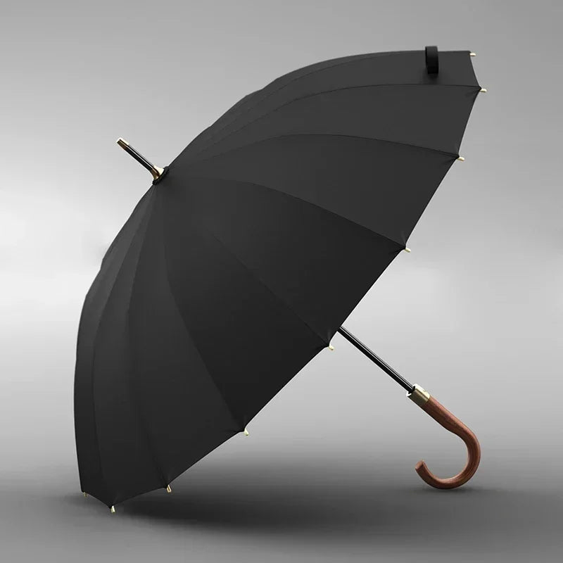 Black umbrella with wooden handle on a gray background
