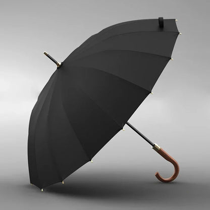 Black umbrella with wooden handle on a gray background