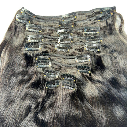 Set of hair extensions with clips on a gray background