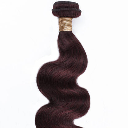 Brown hair extensions with a gold band on a white background