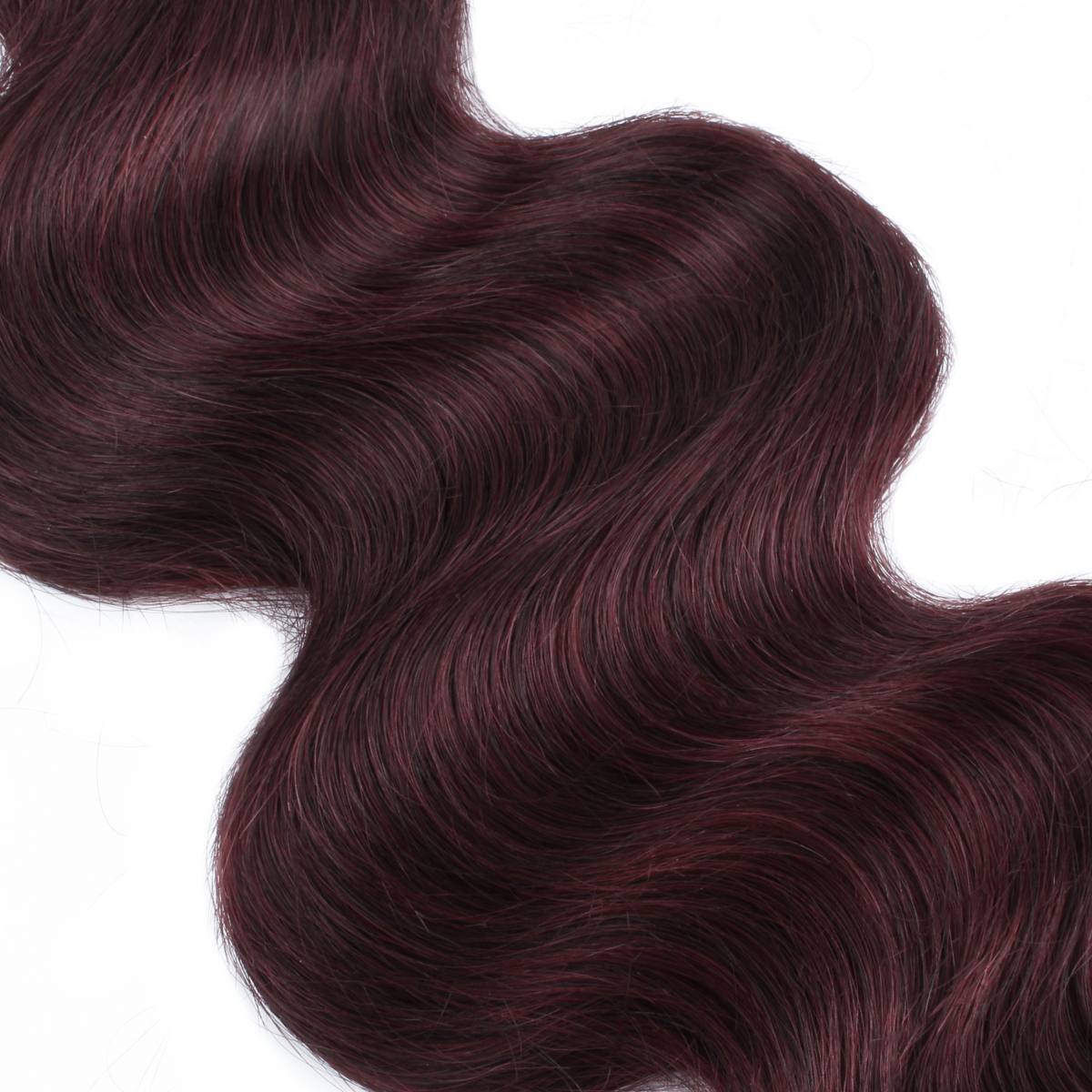 Close-up of dark red hair extensions on a white background