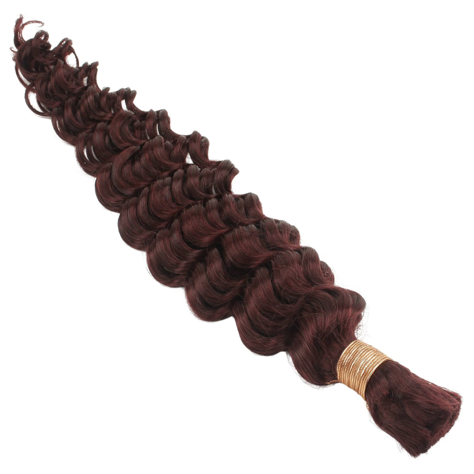Brown hair extensions with a gold clip on a white background