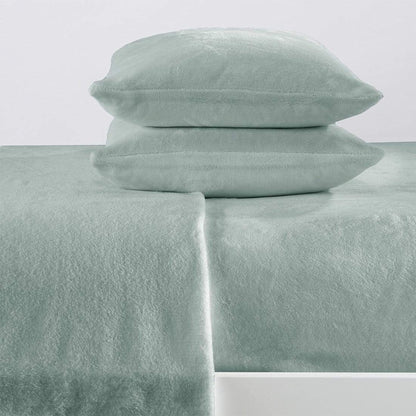 Mint green bed sheets and pillowcases on a white background