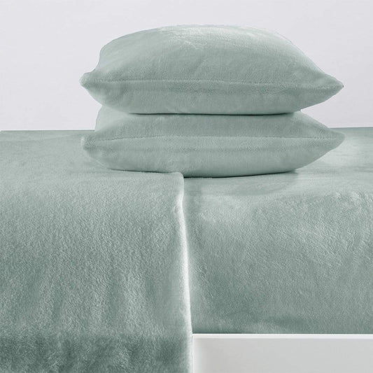 Mint green bed sheets and pillowcases on a white background