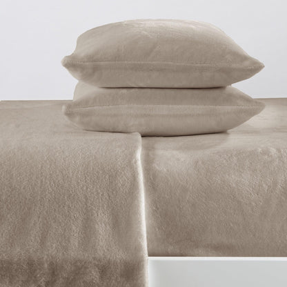 Beige bed sheets and pillows on a white background