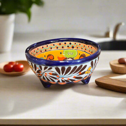 Decorative ceramic bowl with colorful patterns on a kitchen counter