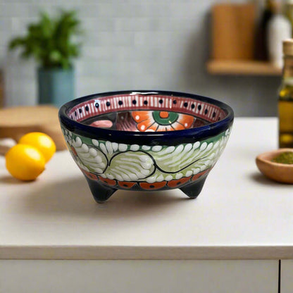 Decorative ceramic bowl with colorful patterns on a kitchen counter.