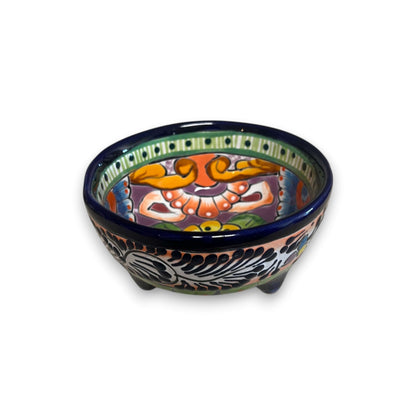 Decorative ceramic bowl with colorful patterns on a white background