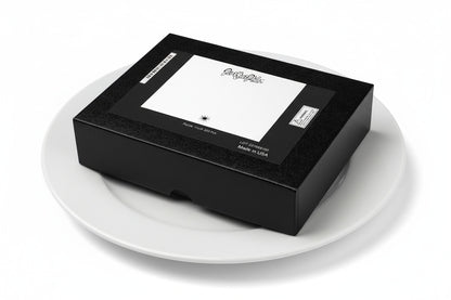 Paint Your Palette brand jigsaw puzzle box on a white dinner plate.