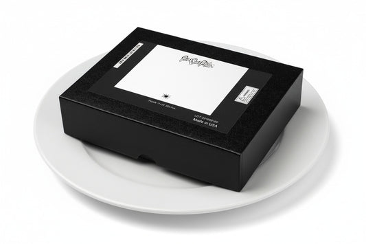 Paint Your Palette brand jigsaw puzzle box on a white dinner plate.