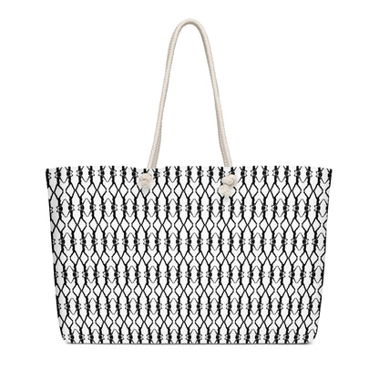 Black and white patterned tote bag with a rope handle on a white background