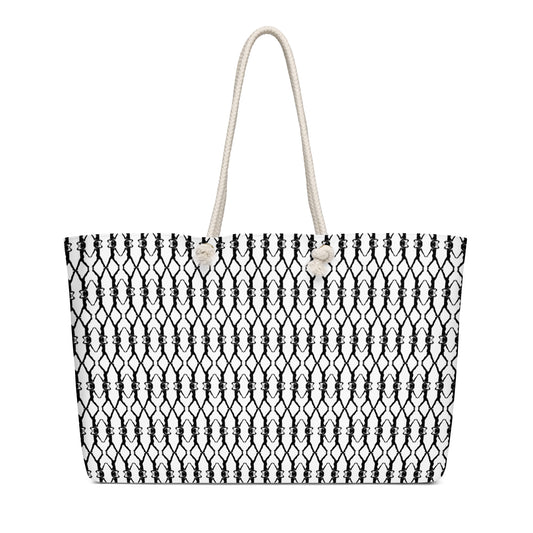 Black and white patterned tote bag with a rope handle on a white background