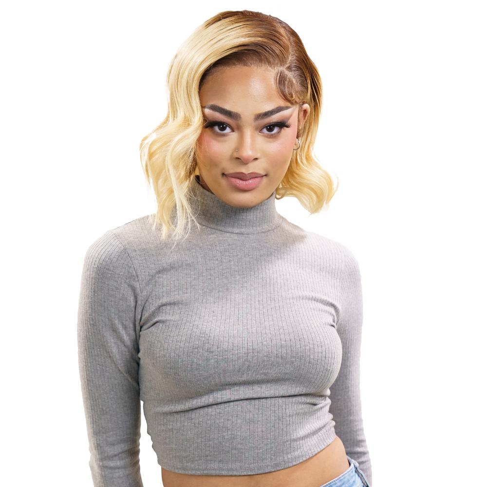 Woman wearing a gray long-sleeve crop top against a white background