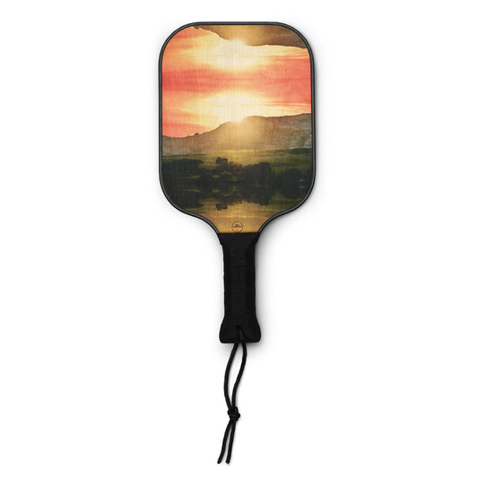 beautiful sunset behind a mountain on a pickleball paddle