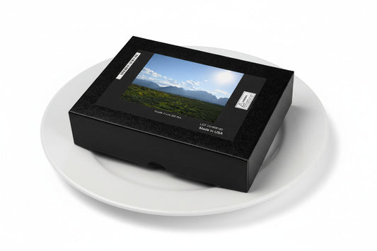 Your Suggested Brand jigsaw puzzle box on a plate with a scenic landscape cover on a white background, on a dinner plate.