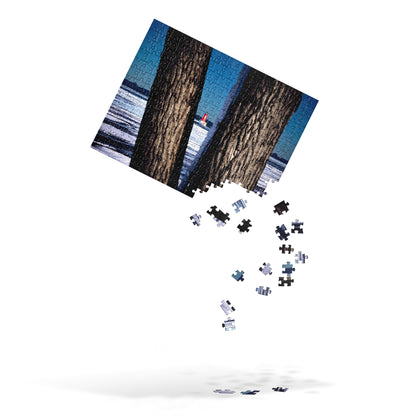 Your Suggested Brand jigsaw puzzle with image of a snowy lake and lighthouse with the pieces falling from the bottom right corner, over a white background.