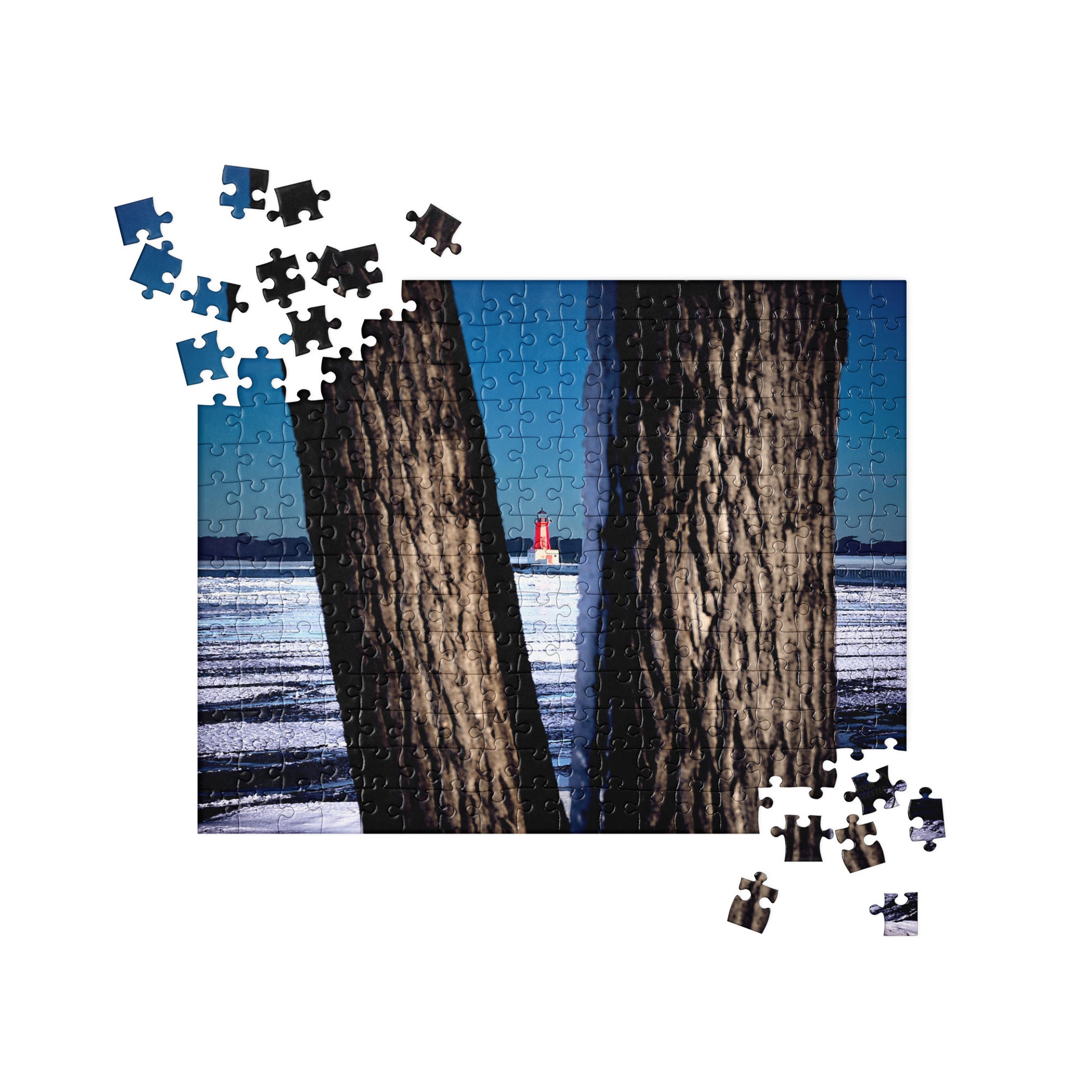 Your Suggested Brand jgsaw puzzle with a completed section showing two trees by a body of water.
