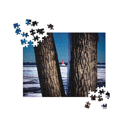 Your Suggested Brand jgsaw puzzle with a completed section showing two trees by a body of water.