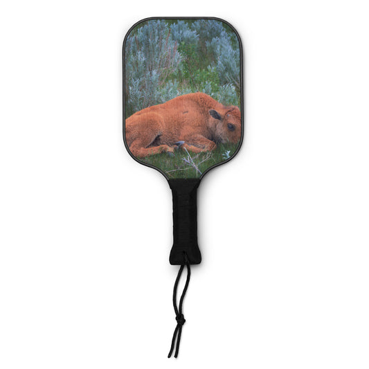 Your Suggested Brand Paddle with a design of a bison lying in a forest on a white background